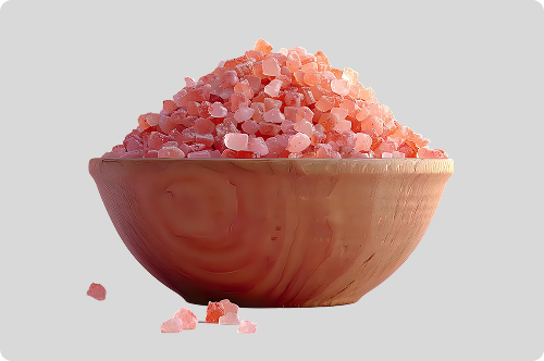 Pink salt granules in a wooden bowl